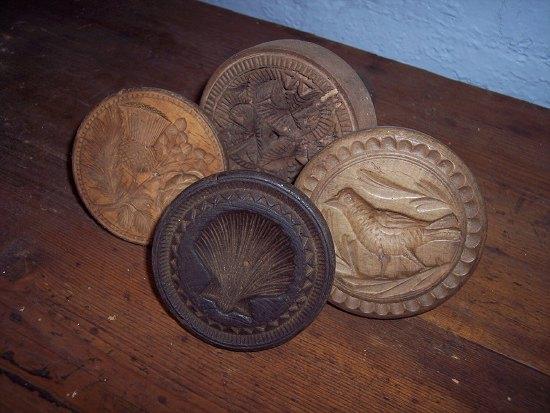 Appraisal: Four treen butter presses various including thistle shell and bird