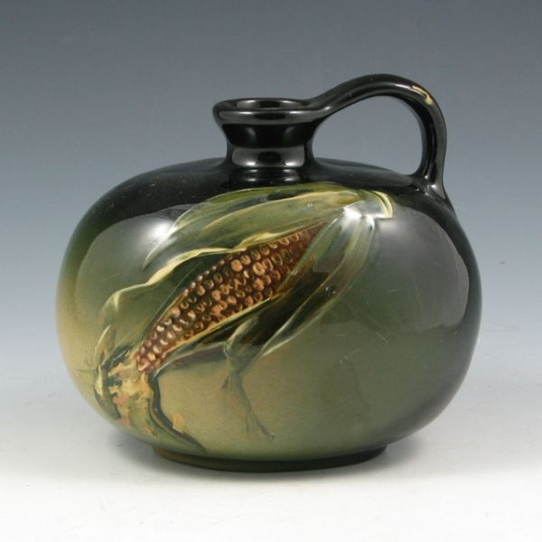 Appraisal: Weller Louwelsa corn jug with green background under standard glaze