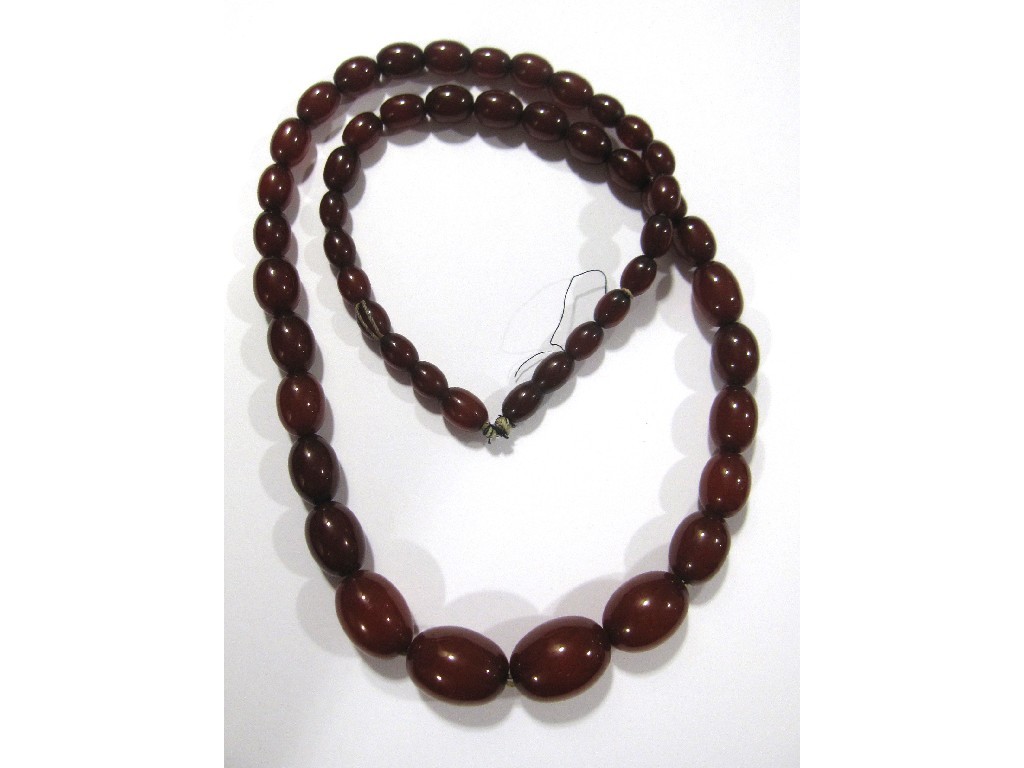 Appraisal: String of red amber beads Approximately in