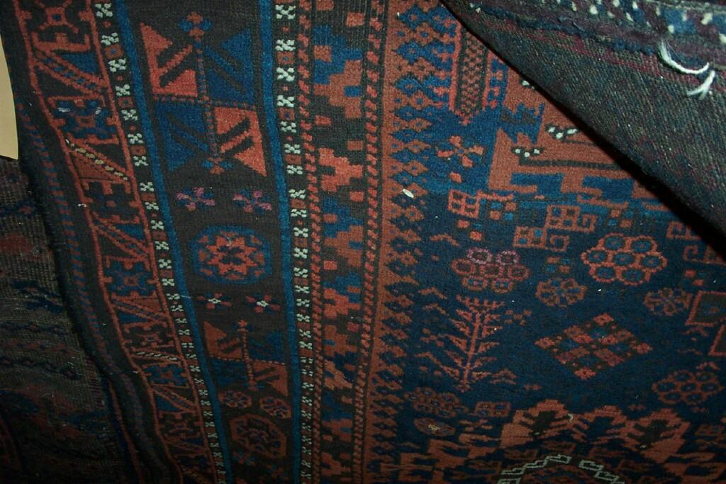 Appraisal: An Eastern wool rug with geometric decoration in red brown