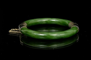 Appraisal: A Carved Jade Hinged Bangle Bracelet A well carved jade