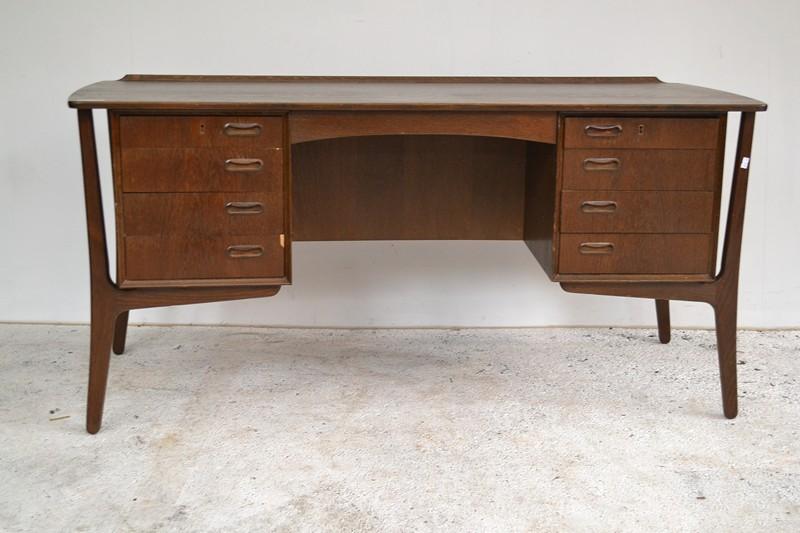 Appraisal: A DANISH EIGHT- DRAWER DESK x x cm DANISH EIGHT-DRAWER