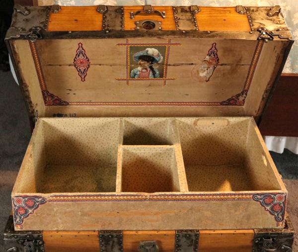 Appraisal: AN IRON MOUNTED WOOD SLAT TRAVEL TRUNK CIRCA The honey-colored