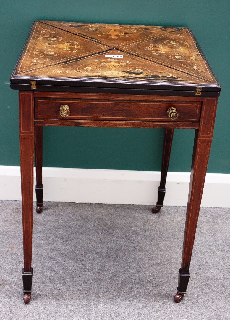 Appraisal: A Victorian marquetry inlaid rosewood envelope card table on tapering