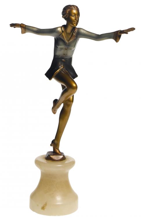 Appraisal: AN ART DECO GILT AND PATINATED SPELTER STATUETTE OF A