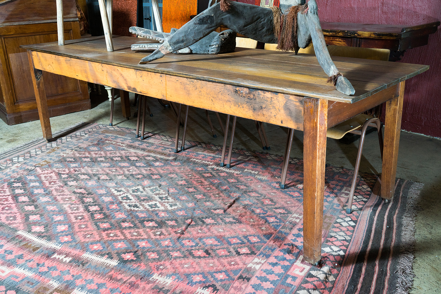 Appraisal: A LARGE RUSTIC DINING TABLE Aged timber sections on solid