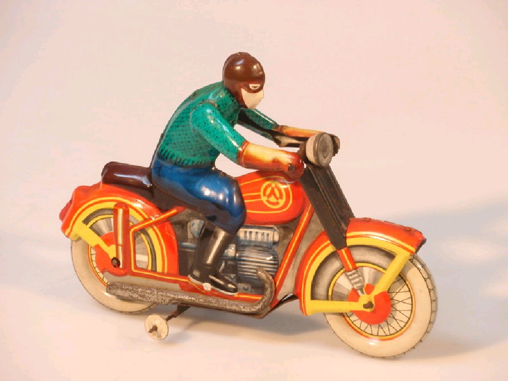 Appraisal: A vintage tin plate clockwork motor cycle figure