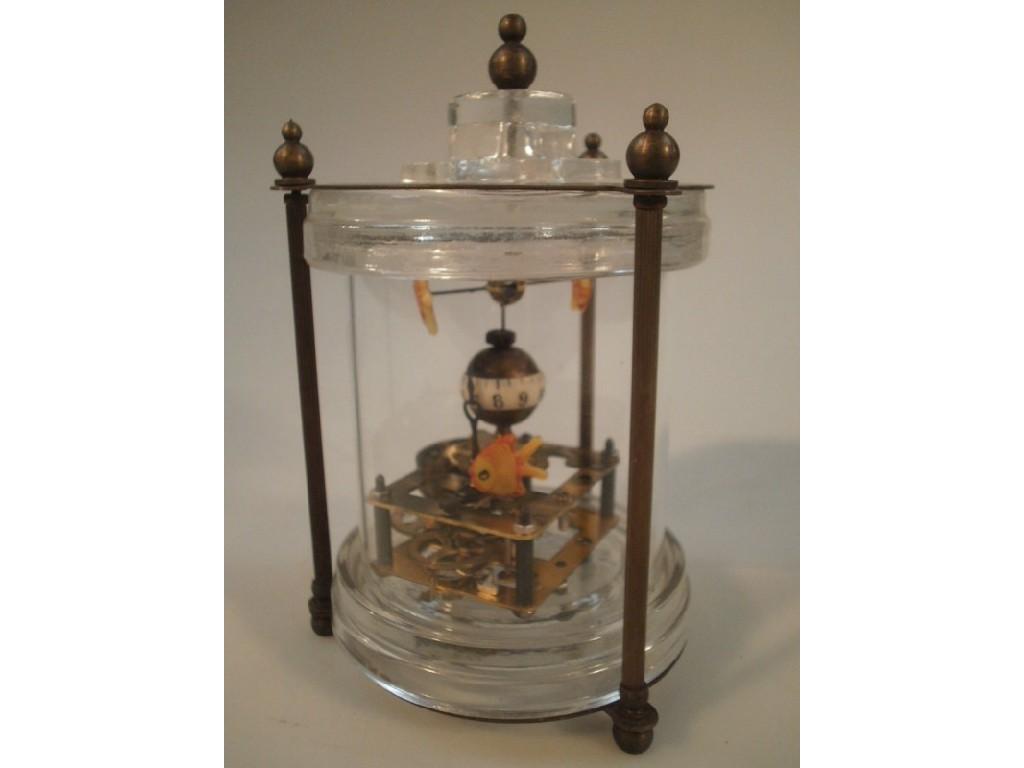 Appraisal: A Chinese cylindrical glass cased fish mystery clock with metal