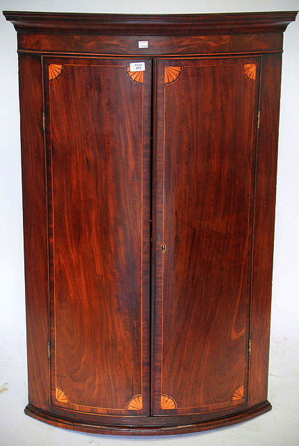 Appraisal: A GEORGE III MAHOGANY BOW FRONTED HANGING CORNER CUPBOARD with