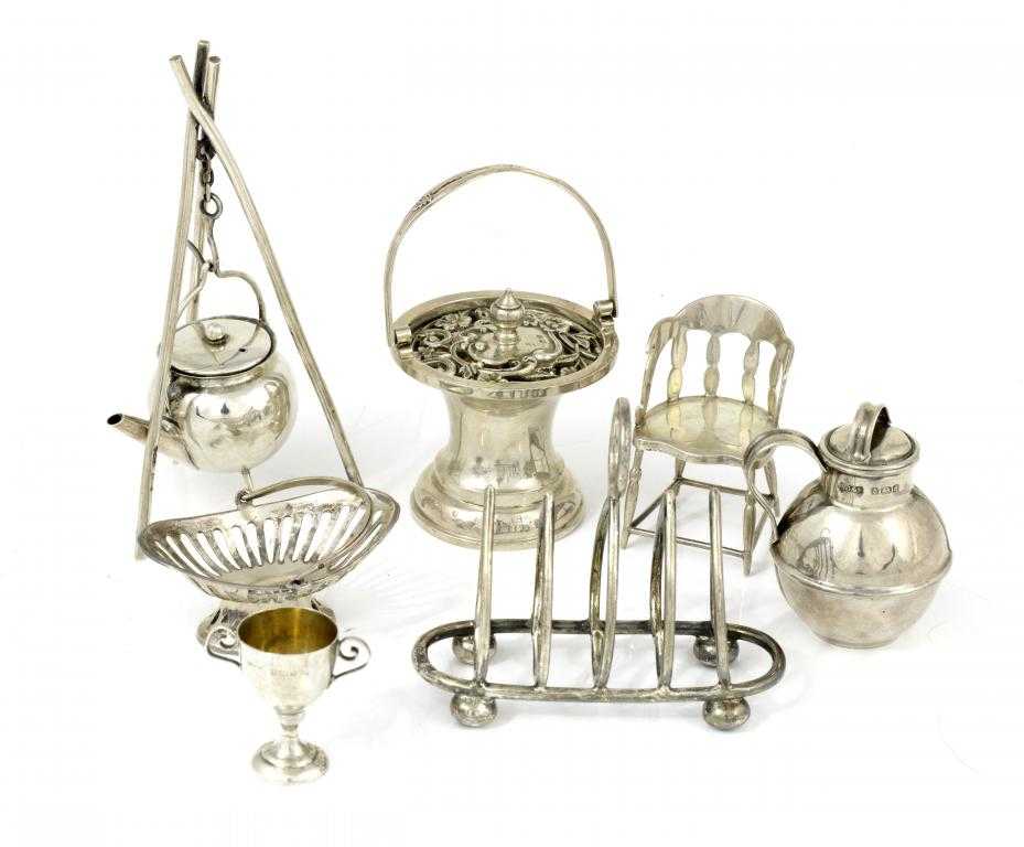 Appraisal: SEVEN ENGLISH SILVER TOYS comprising a gipsy kettle and stand