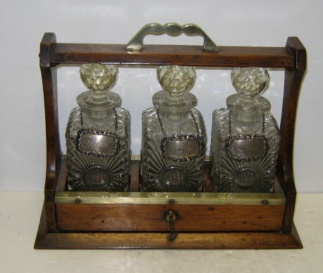 Appraisal: ENGLISH TH CENTURY OAK TANTALUS Typical form with brass top