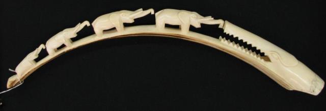 Appraisal: A carved ivory tusk depicting a crocodile and four elephants