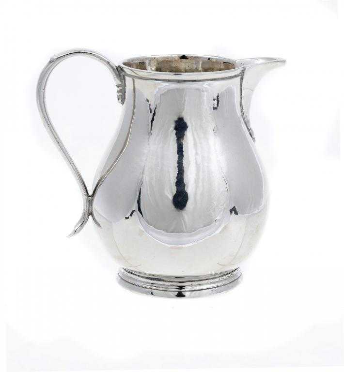 Appraisal: A GEORGE II CREAM JUG of baluster shape with loop