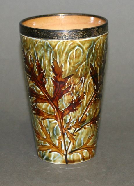 Appraisal: A Doulton Lambeth salt glaze beaker shaped vase with natural