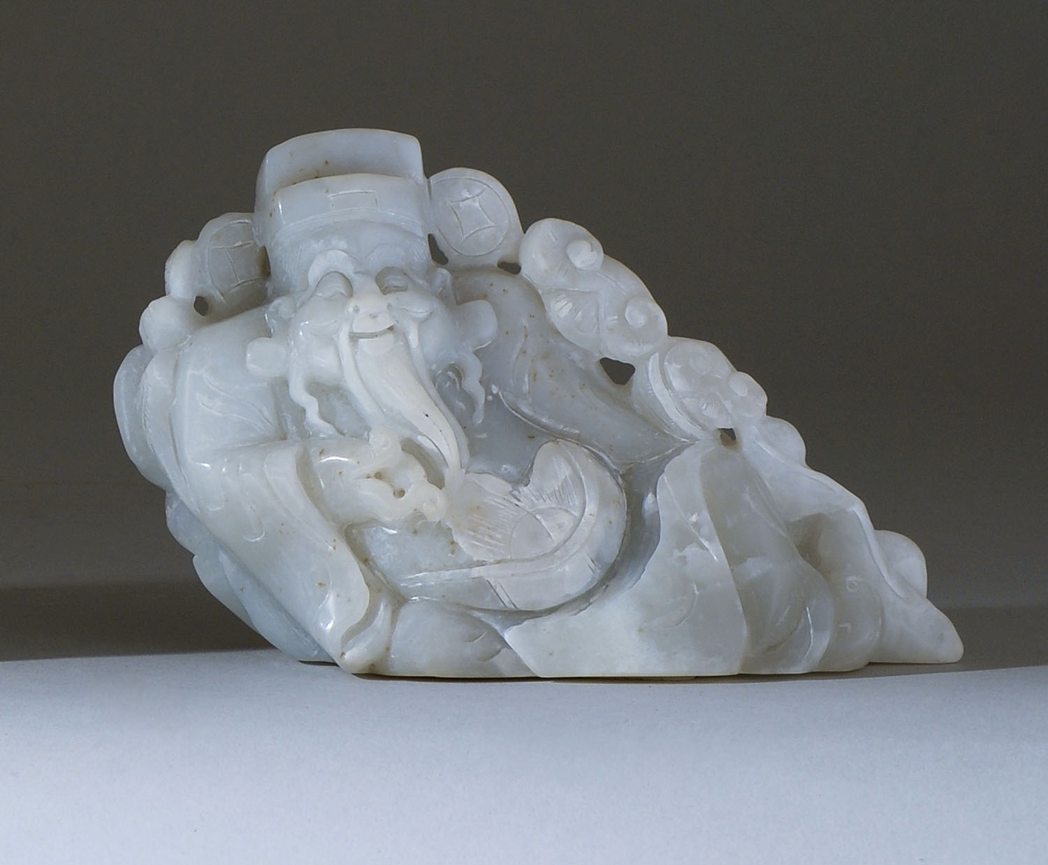 Appraisal: GRAY JADE CARVING OF SHOULAO In reclining position with ruyi