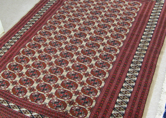 Appraisal: HAND KNOTTED BOKHARA CARPET with a field of Turkoman gols