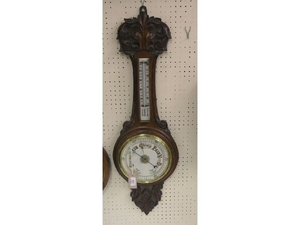 Appraisal: A Victorian carved oak wheel barometer with thermometer dial in