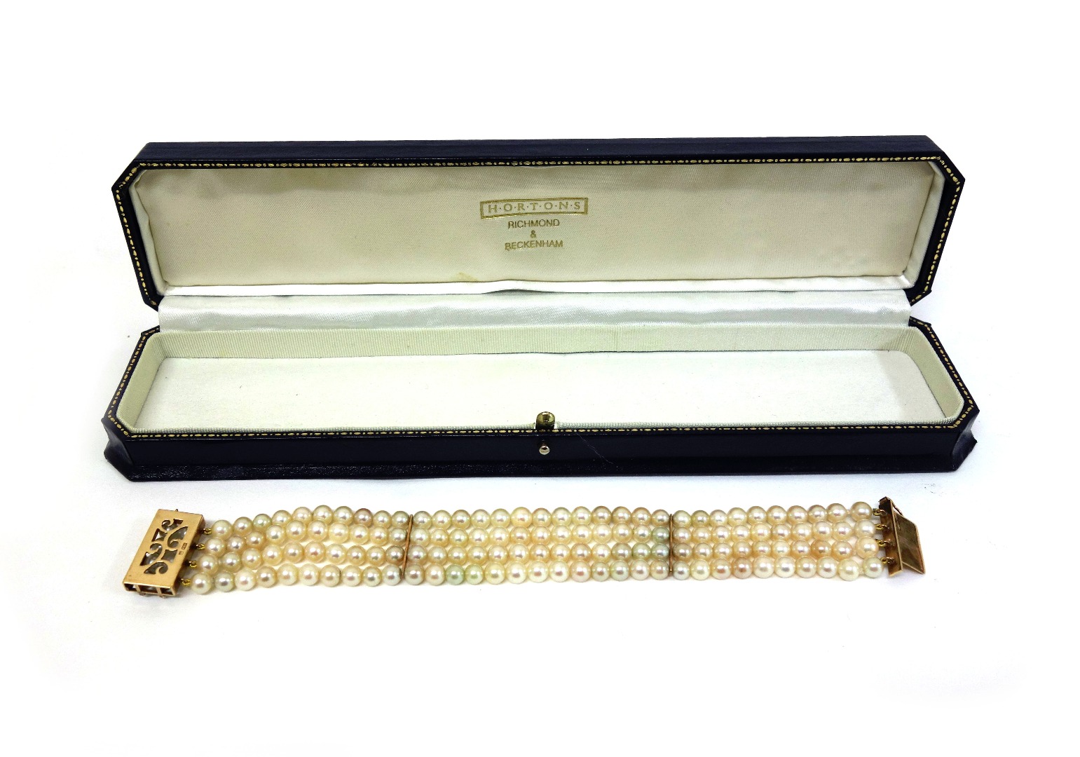 Appraisal: A four row cultured pearl bracelet with a gold and