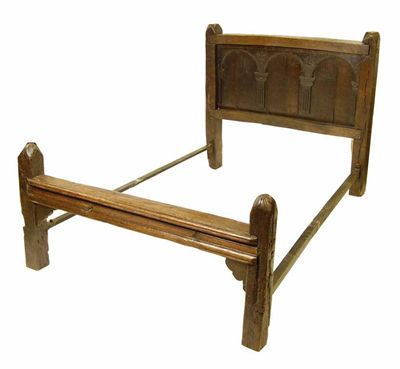 Appraisal: An oak bedstead with a panelled headboard having three arches