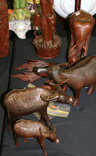 Appraisal: Three carved figures of water buffalo together with two carved