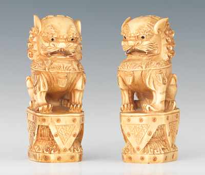 Appraisal: A Pair of Carved Ivory Foo Dogs Regal foo dogs