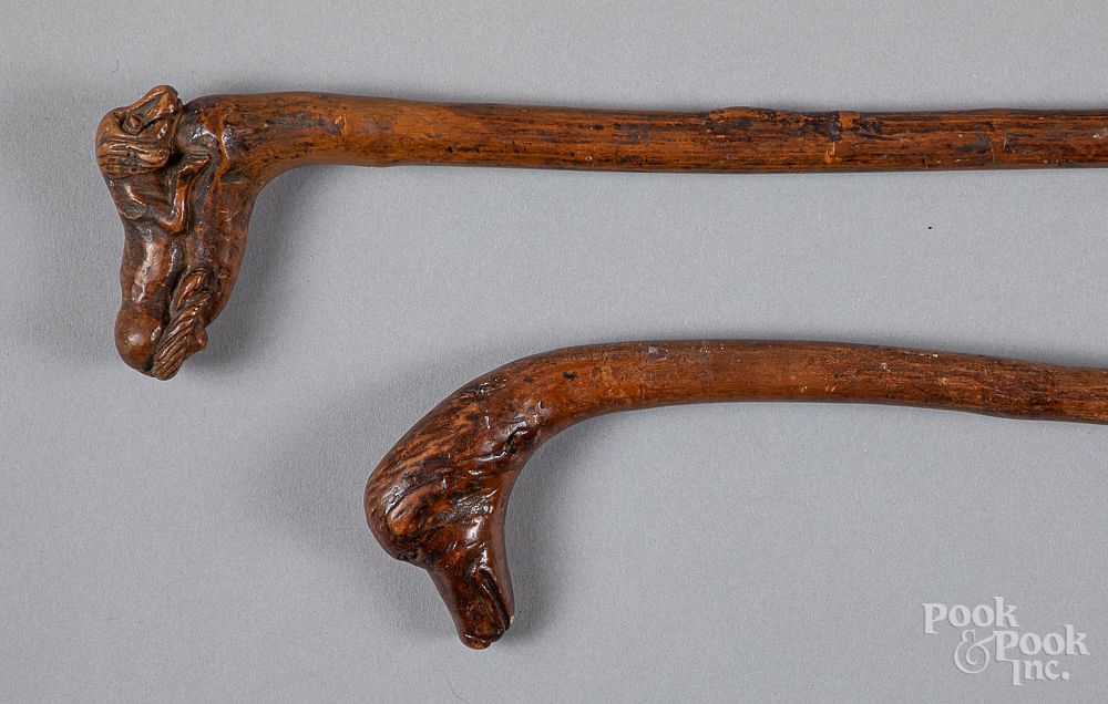 Appraisal: Two carved canes ca Two carved canes ca with dog