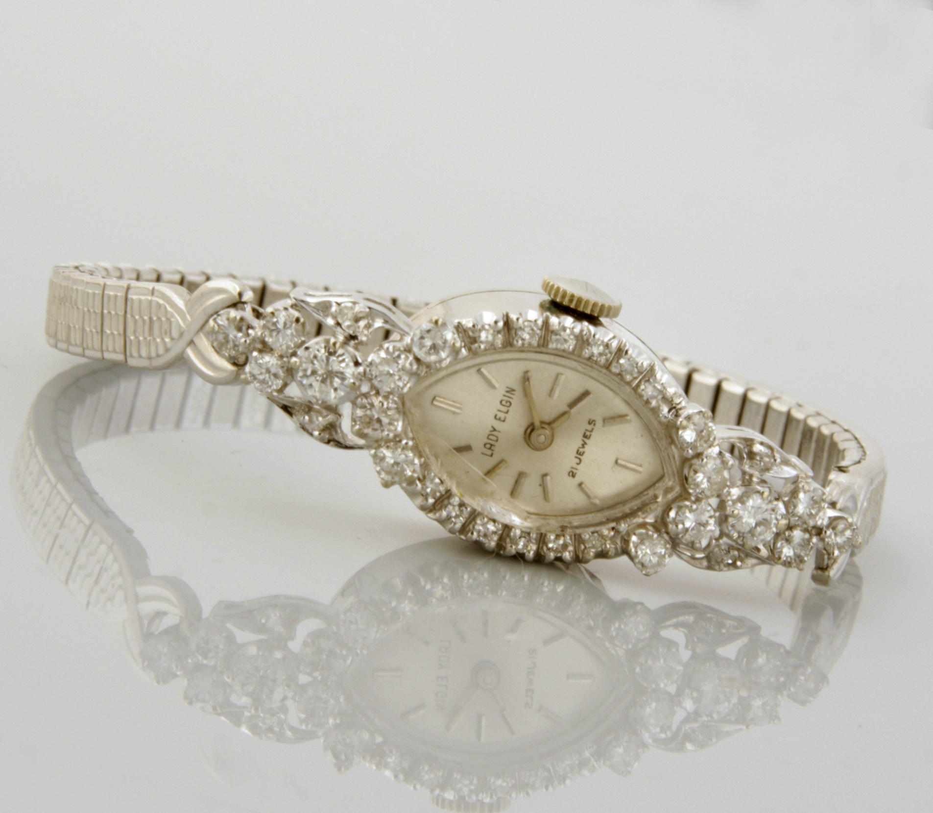 Appraisal: A diamond and white gold wristwatch Elgin with metal expansion