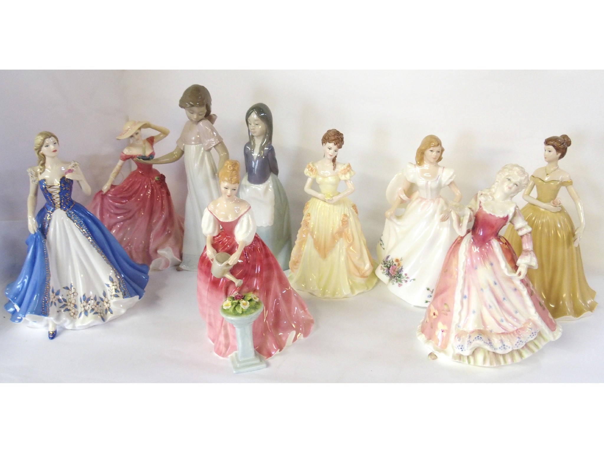 Appraisal: Group of nine figures comprising two Nao five Royal Doulton