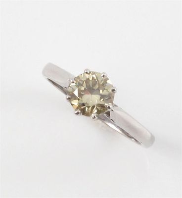 Appraisal: A yellow diamond solitaire ring The circular cut diamond weighs