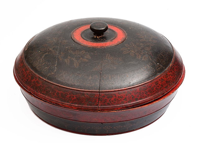 Appraisal: A Burmese red and black lacquer bowl and coverdecorated with