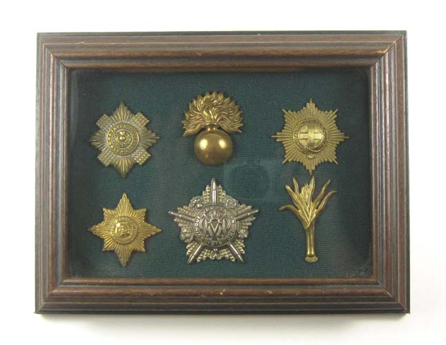 Appraisal: SIX WORLD WAR ONE GUARD CAP BADGES including Royal Irish