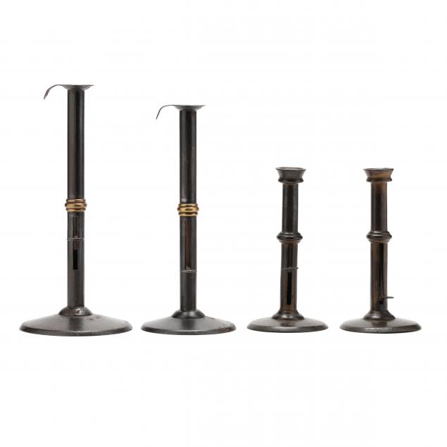 Appraisal: A GROUPING OF FOUR HOGSCRAPER CANDLESTICKS Circa sheet iron each