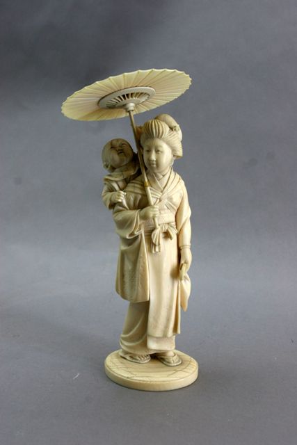 Appraisal: A Meiji Japanese ivory figure of a mother carrying child