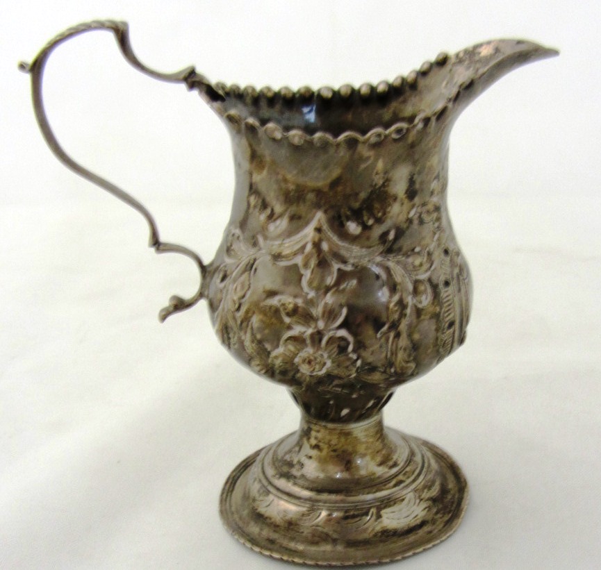 Appraisal: A silver cream jug with floral and foliate embossed decoration