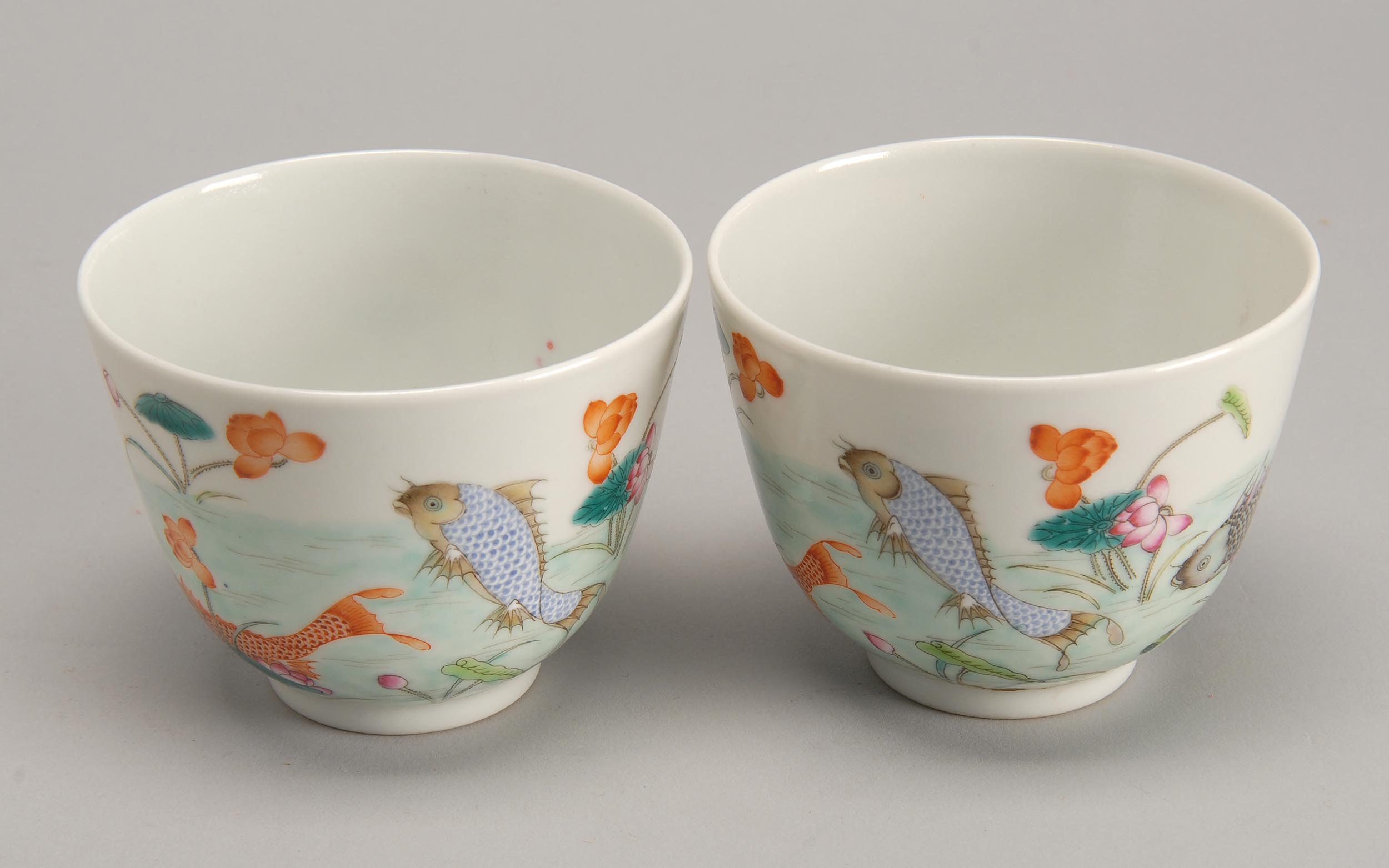 Appraisal: PAIR OF FAMILLE ROSE PORCELAIN TEACUPS With colorful carp and