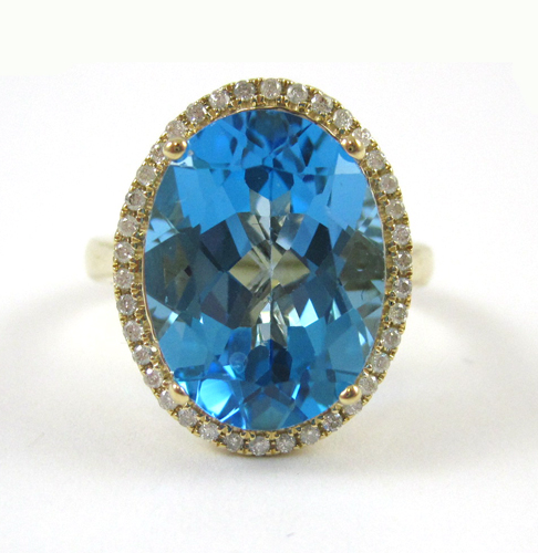 Appraisal: BLUE TOPAZ AND DIAMOND RING k yellow gold with round-cut