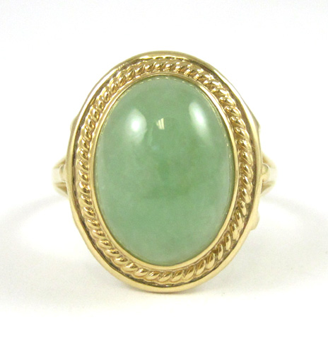 Appraisal: JADE AND FOURTEEN KARAT GOLD RING set with a single