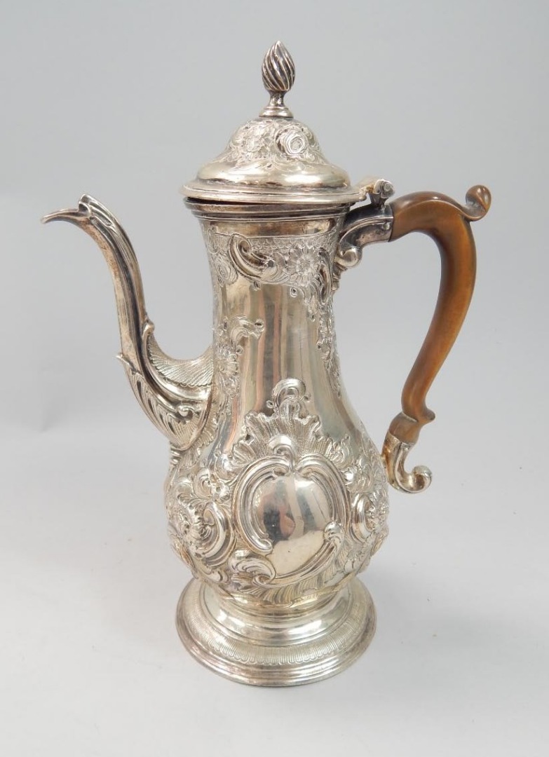 Appraisal: A George III silver coffee pot embossed with flowers scrolls