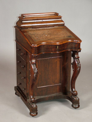 Appraisal: An early Victorian rosewood Davenport the raised hinged three quarter