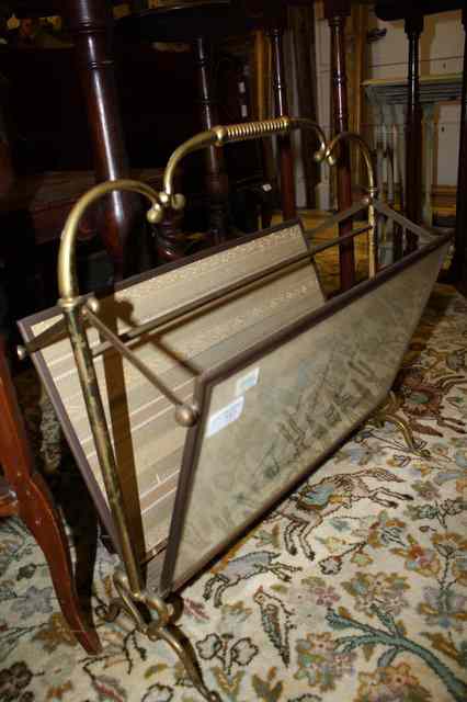 Appraisal: A BRASS MAGAZINE RACK with scrolling handle the sides decorated