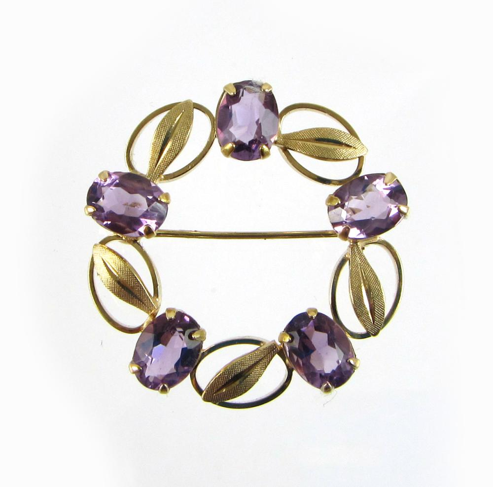 Appraisal: AMETHYST AND FOURTEEN KARAT GOLD BROOCH The round shaped wreath