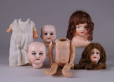 Appraisal: SMALL DOLL PARTS Includes two bisque heads with sleep eyes