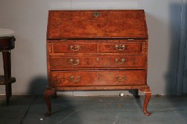 Appraisal: A George II walnut bureau on later legs restorations some