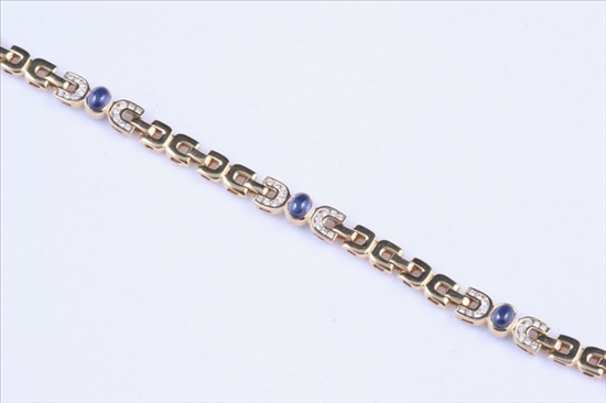 Appraisal: K YELLOW GOLD SAPPHIRE AND DIAMOND FLEXIBLE LINK BRACELET Three