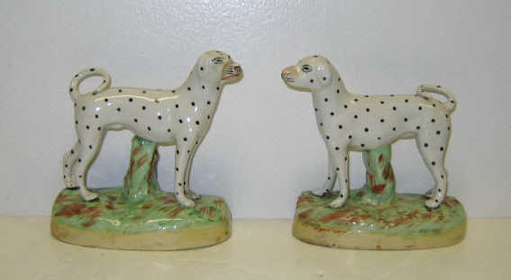 Appraisal: PAIR OF STAFFORDSHIRE DALMATION FIGURES Painted overglaze creamware each dog