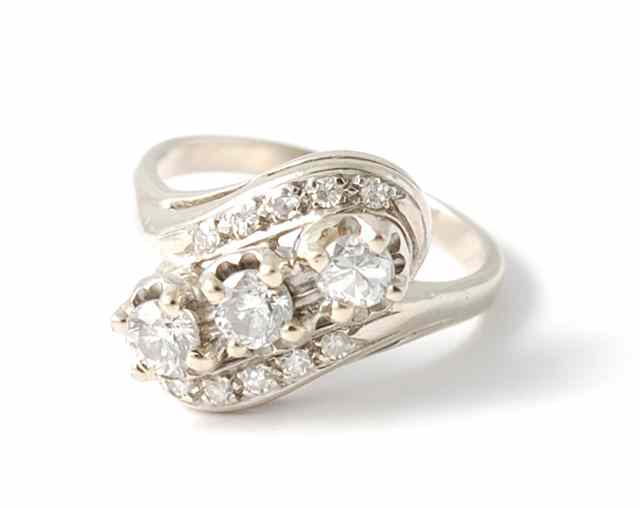 Appraisal: DIAMOND AND FOURTEEN KARAT WHITE GOLD RING featuring a centralized