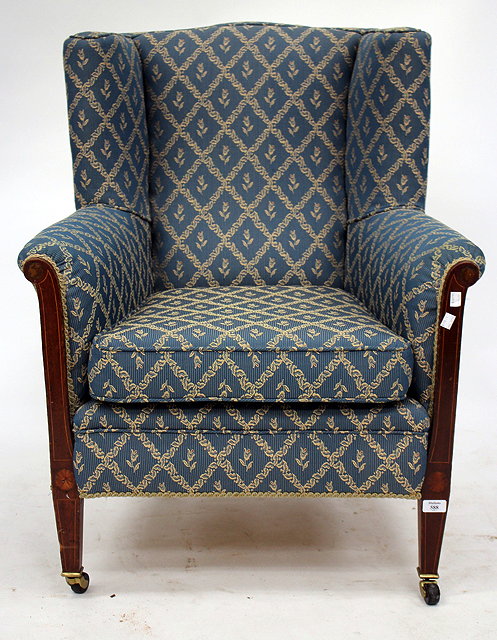 Appraisal: AN EDWARDIAN MAHOGANY WING BACK ARMCHAIR with square tapering legs