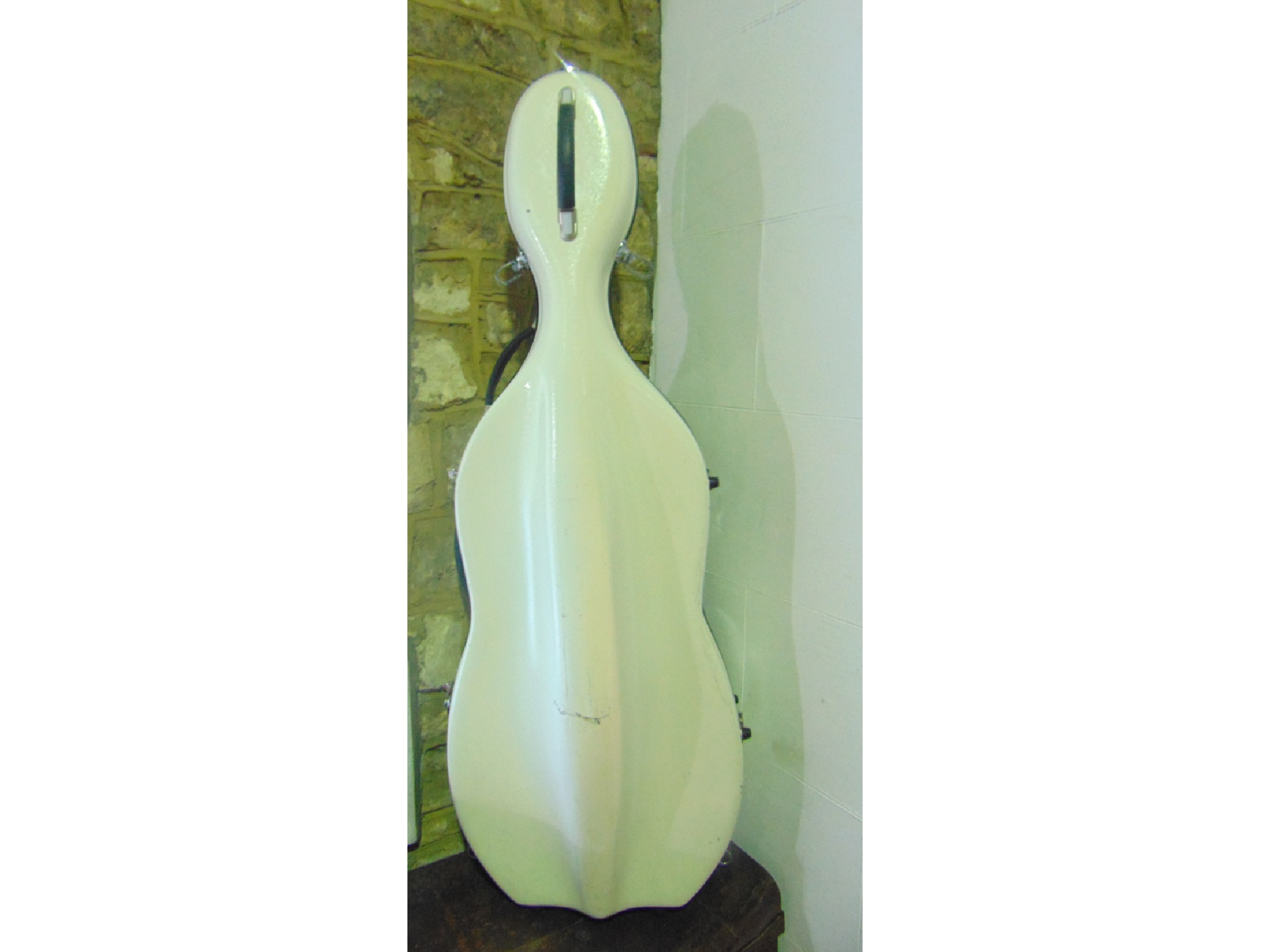 Appraisal: A cello case in white fibre glass