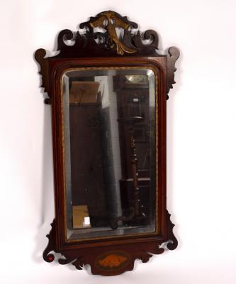 Appraisal: A mahogany wall mirror the frame with gilded griffin and