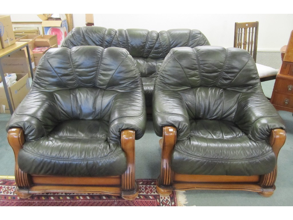 Appraisal: Green leather settee with a pair of matching armchairs